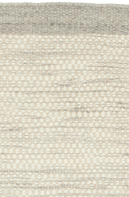 Handgeweven wollen vloerkleed Anna Ijzer interieur detail