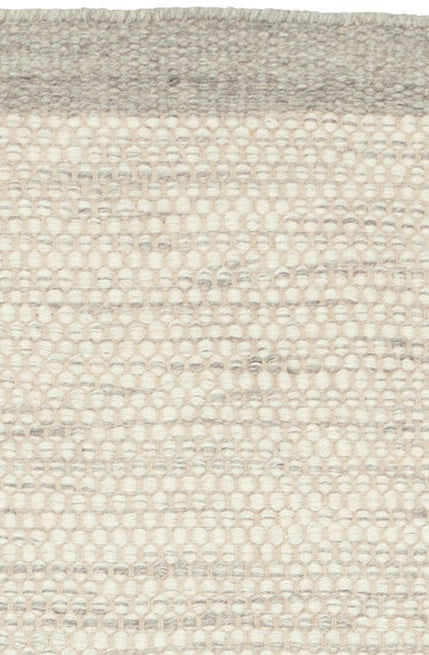 Handgeweven wollen vloerkleed Anna Ijzer interieur detail